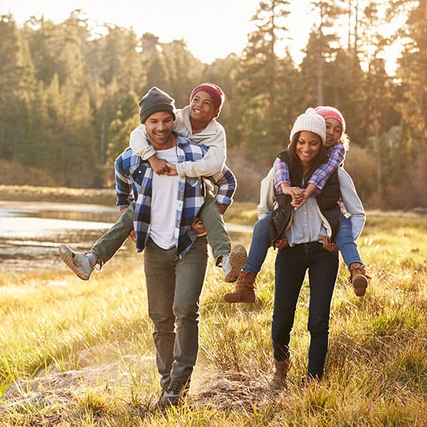 FamilyofFourHiking Family of Four hiking by a river